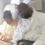 Kanye West spotted flying Economy with wife